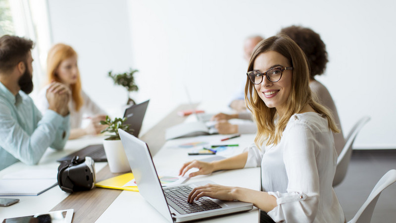 Die Menschen arbeiten am Tisch und unterhalten sich.